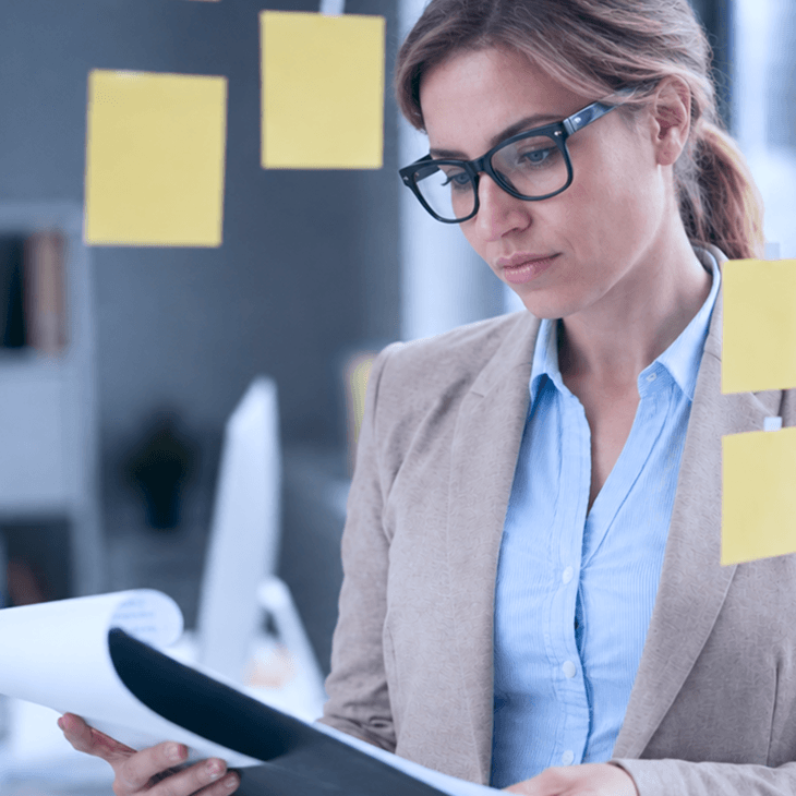 A professional reviewing priorities on sticky notes