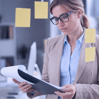 A professional reviewing priorities on sticky notes